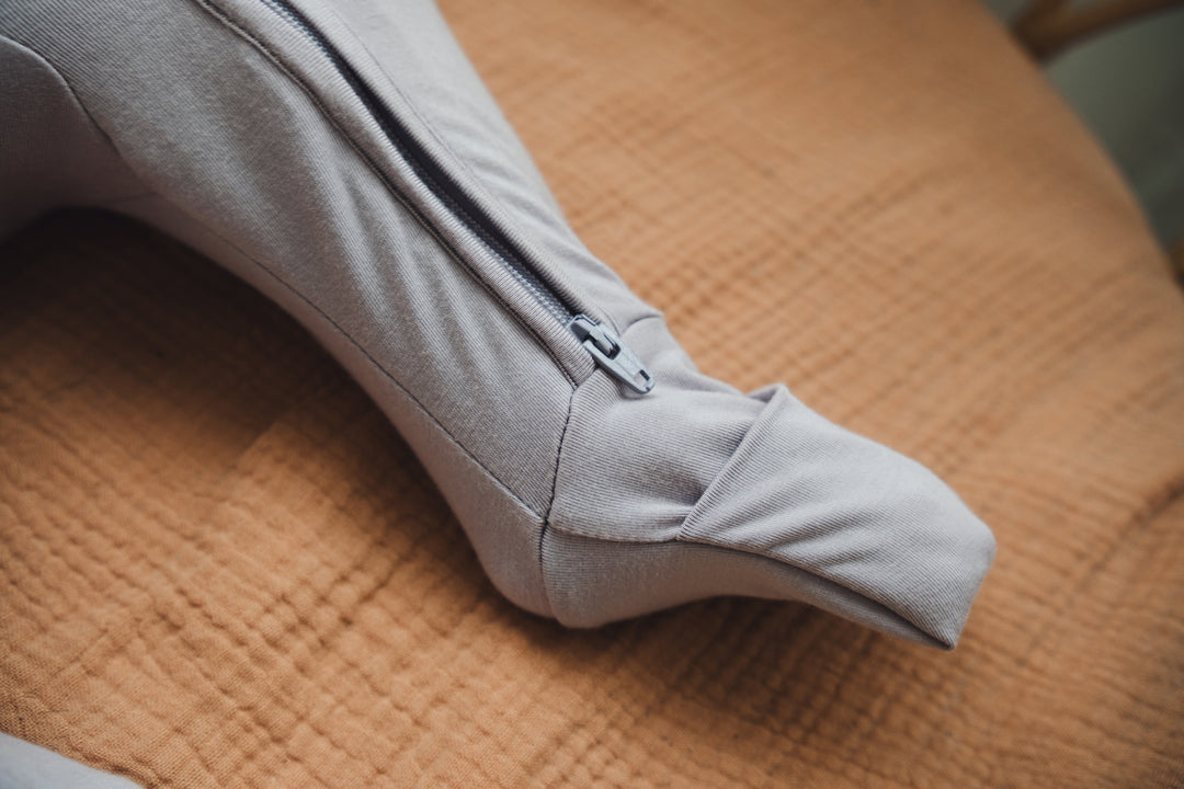 Close-up showing the fold-over leg mitten of a baby sleep suit