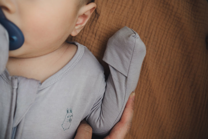 Close-up of fold-over hand mitten on the lavender sleep suit
