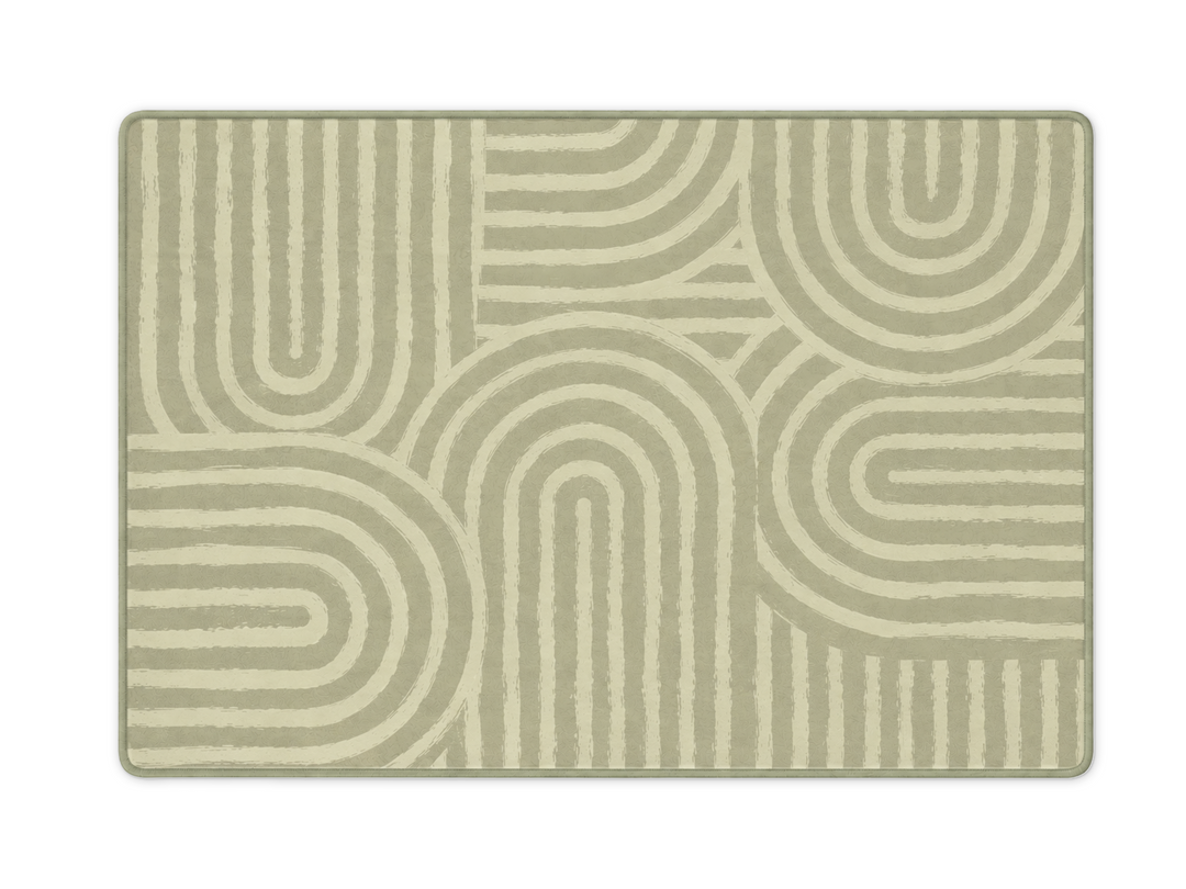 Lollibly Kaya Plush Playmat in XL (300 × 200cm). A rectangular area rug with a modern geometric pattern of concentric arches and lines in sage green and cream.