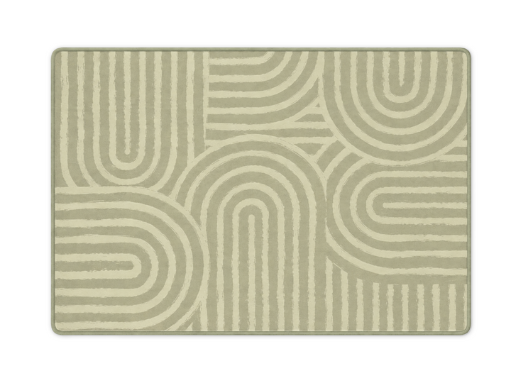 Lollibly Kaya Plush Playmat in XL (300 × 200cm). A rectangular area rug with a modern geometric pattern of concentric arches and lines in sage green and cream.