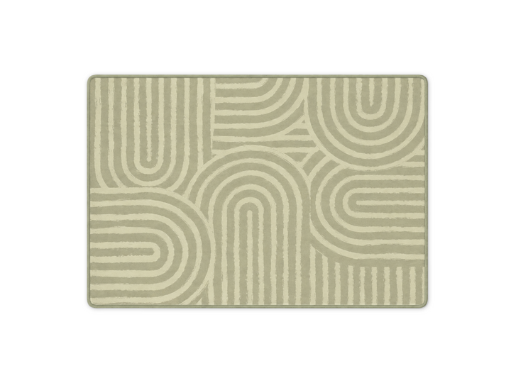 Lollibly Kaya Plush Playmat in Big One (200 × 140cm). A rectangular area rug with a modern geometric pattern of concentric arches and lines in sage green and cream.
