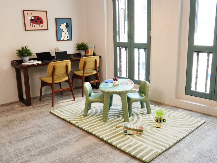 A study area, with a children play area set up nearby, on top of the Lollibly Kaya Plush Playmat.