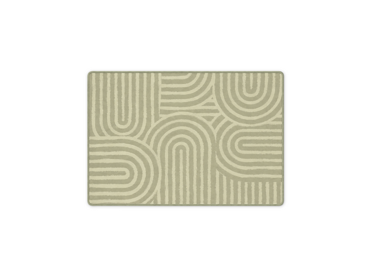 Lollibly Kaya Plush Playmat in Little One (100 × 140cm). A rectangular area rug with a modern geometric pattern of concentric arches and lines in sage green and cream.