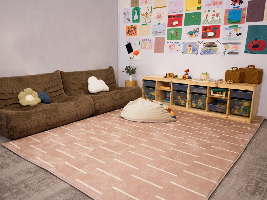 The XL Lollibly Shortbread Plush Playmat displayed in a cosy living room.