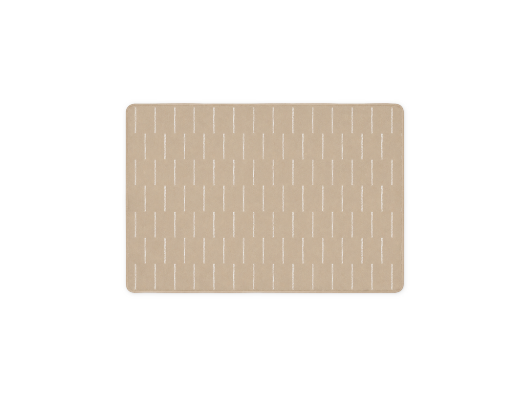 Lollibly Shortbread Plush Playmat in Little One (100 × 140 cm). A rectangular beige mat with rounded corners, featuring a repeating pattern of thin vertical white lines.